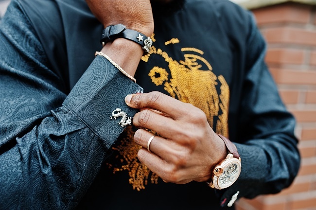 Close up hands of rich african man with watch and cufflinks. Close up hands of rich african man with watch and cufflinks.