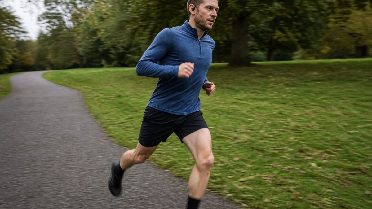 Runner wearing hooked wireless sport earbuds during an outdoor run