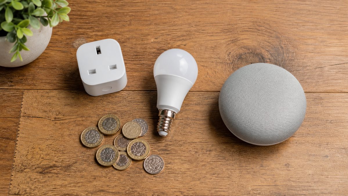 Flat-lay of a small smart plug, bulb and speaker starter bundle with UK coins