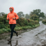 Runner wearing a waterproof running jacket on a rainy UK country lane